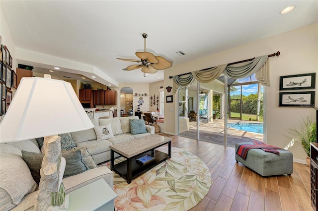 8136 Snowy Egret Pl, Bradenton, FL 34202 - living area with arched walkways, a ceiling fan, light wood-type flooring, and recessed lighting