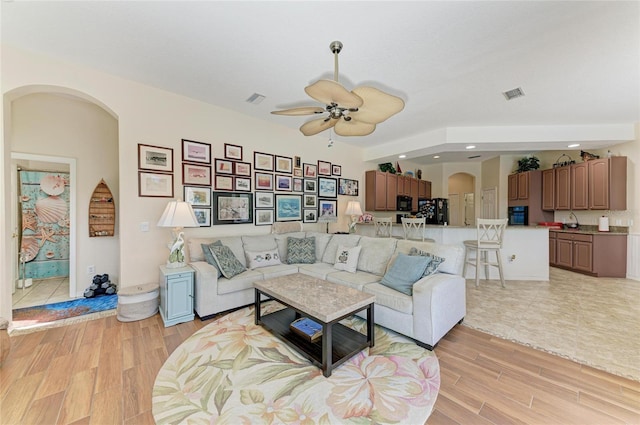 8136 Snowy Egret Pl, Bradenton, FL 34202 - living room featuring arched walkways, a ceiling fan, light wood-style floors, and recessed lighting