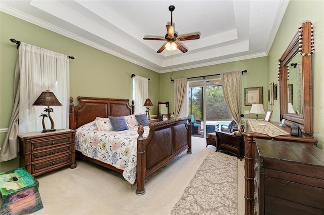 8136 Snowy Egret Pl, Bradenton, FL 34202 - bedroom featuring a tray ceiling, light carpet, ornamental molding, and ceiling fan