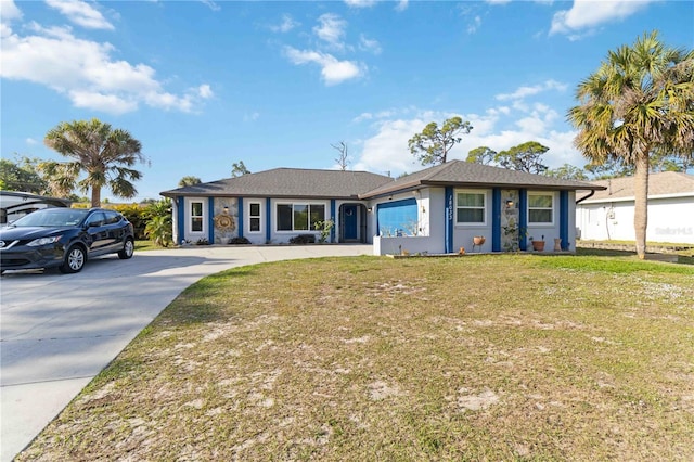 18033 Edgewater Dr, Port Charlotte, FL 33948 - single story home with driveway, an attached garage, stucco siding, and a front yard