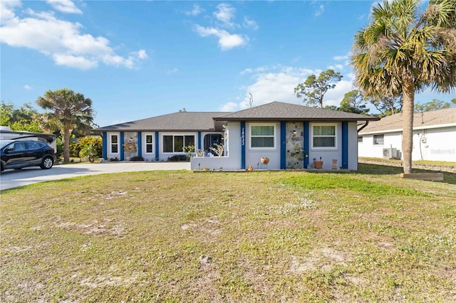 18033 Edgewater Dr, Port Charlotte, FL 33948 - single story home with a front yard, driveway, and stucco siding