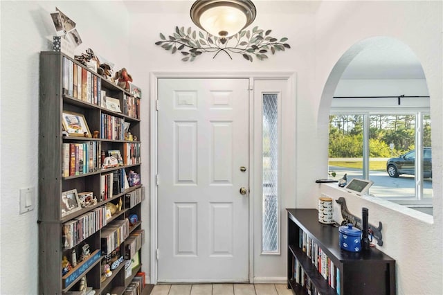 18033 Edgewater Dr, Port Charlotte, FL 33948 - foyer entrance with light tile patterned flooring and arched walkways