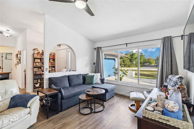 18033 Edgewater Dr, Port Charlotte, FL 33948 - living room with arched walkways, ceiling fan, wood finished floors, and vaulted ceiling