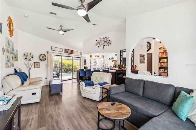 18033 Edgewater Dr, Port Charlotte, FL 33948 - living room with a ceiling fan, visible vents, vaulted ceiling, and wood finished floors