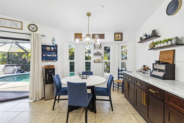 18033 Edgewater Dr, Port Charlotte, FL 33948 - dining room with light tile patterned flooring and an inviting chandelier