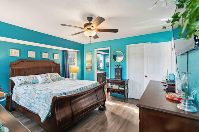 18033 Edgewater Dr, Port Charlotte, FL 33948 - bedroom with connected bathroom, wood finished floors, and ceiling fan