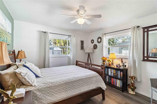 18033 Edgewater Dr, Port Charlotte, FL 33948 - bedroom with baseboards, ceiling fan, wood finished floors, and multiple windows