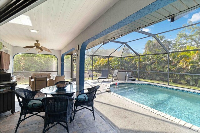 18033 Edgewater Dr, Port Charlotte, FL 33948 - pool with glass enclosure, ceiling fan, an outdoor hangout area, and a patio