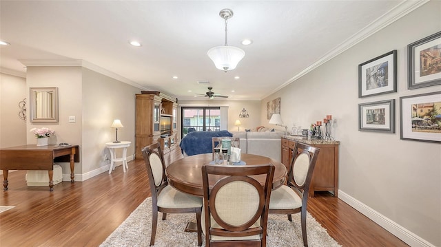 dining area featuring recessed lighting, baseboards, crown molding, and wood finished floors