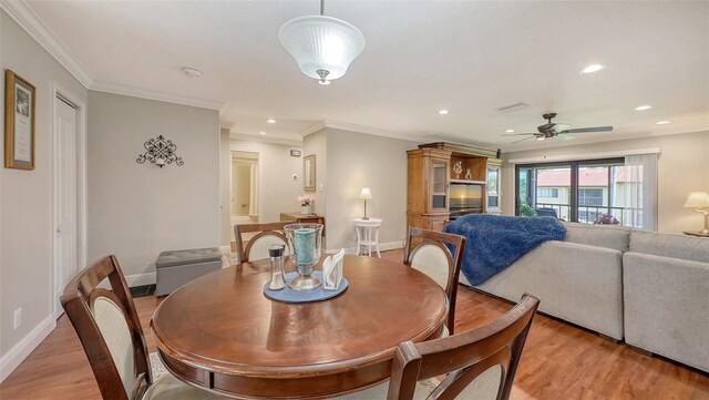 dining area featuring crown molding, light wood-style flooring, a ceiling fan, recessed lighting, and baseboards