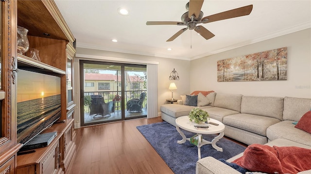 living area with crown molding, wood finished floors, a ceiling fan, and recessed lighting