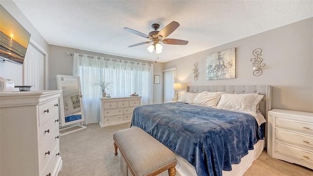 bedroom featuring light carpet and ceiling fan