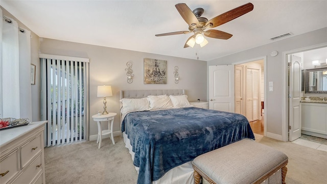 bedroom featuring light carpet, visible vents, baseboards, and connected bathroom