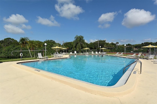 pool featuring fence and a patio