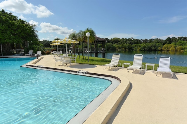 community pool featuring a patio area and a water view