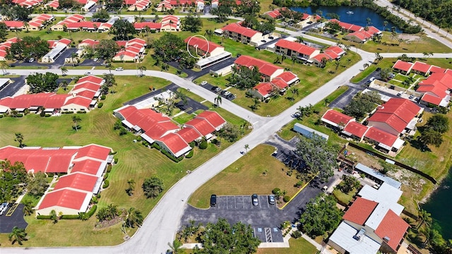 drone / aerial view with a water view and a residential view