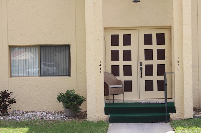 doorway to property with stucco siding