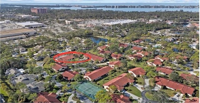 birds eye view of property with a water view and a residential view