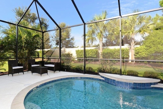 pool with a lanai and a patio area