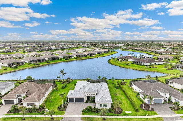 drone / aerial view with a water view and a residential view