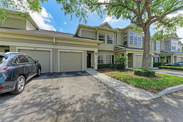 view of property with a garage and driveway