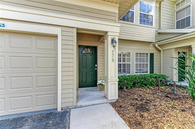 view of exterior entry with a garage