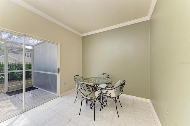 dining room featuring light tile patterned floors, baseboards, and ornamental molding