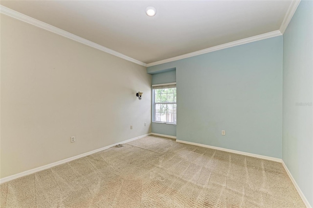 carpeted spare room with baseboards and ornamental molding