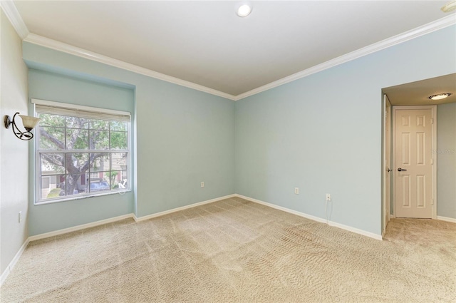 empty room with ornamental molding, baseboards, and carpet