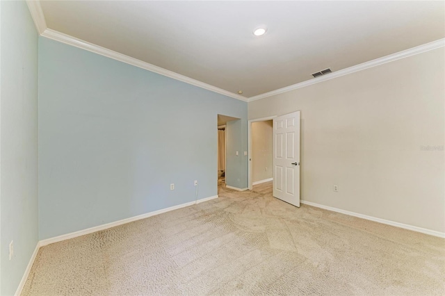 empty room with crown molding, baseboards, and visible vents