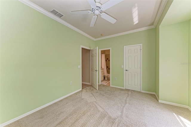 empty room featuring ornamental molding, baseboards, and visible vents