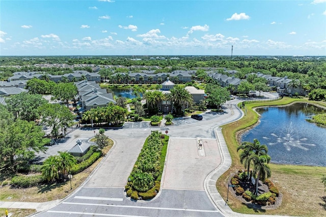 drone / aerial view with a residential view and a water view