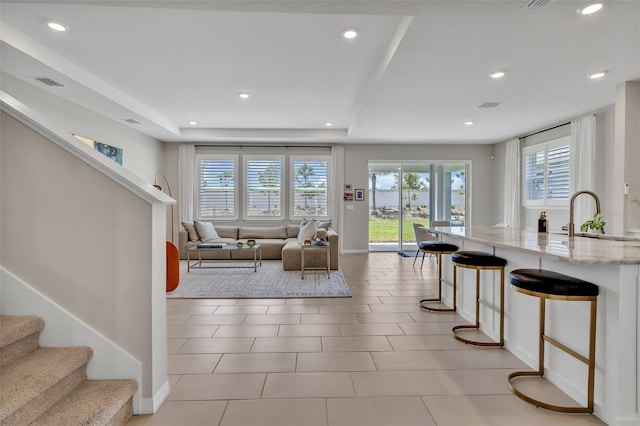 living area with recessed lighting, stairs, and visible vents