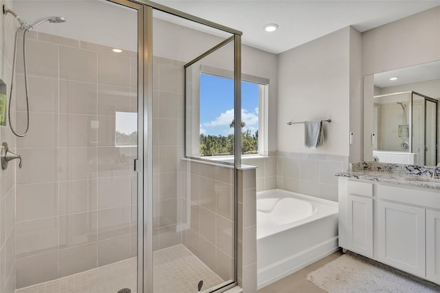 full bath featuring a bath, recessed lighting, vanity, tile patterned floors, and a stall shower