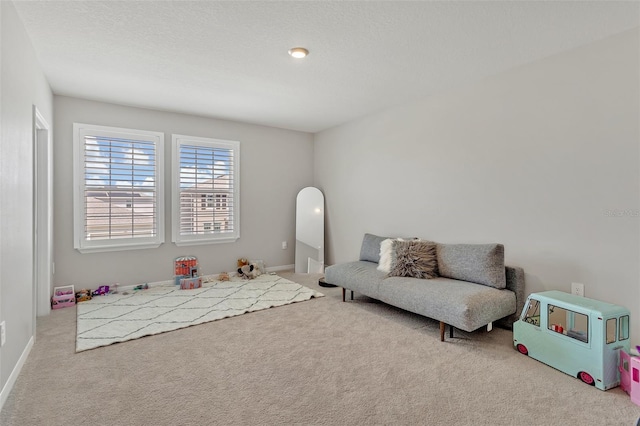 playroom featuring baseboards and carpet floors