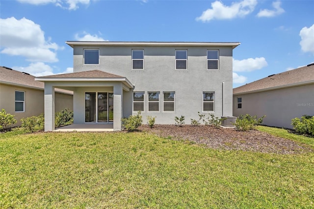 back of property featuring a yard, stucco siding, cooling unit, and a patio area