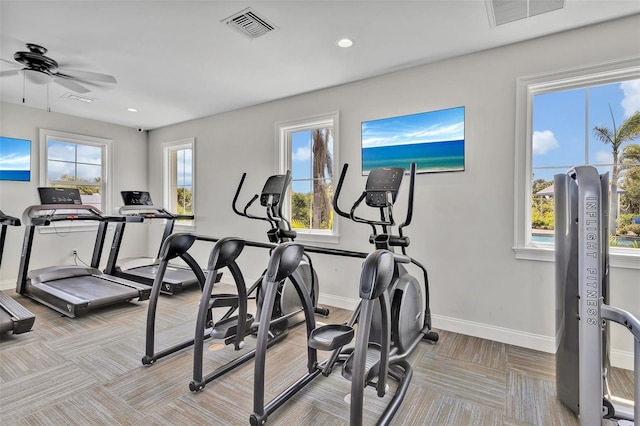 workout area featuring visible vents, baseboards, and a ceiling fan