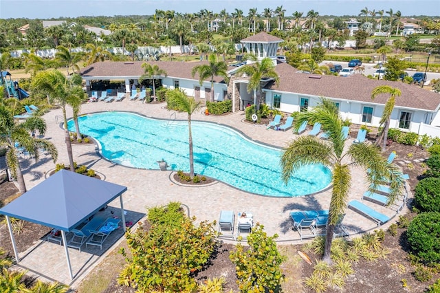 pool with a patio area and a residential view