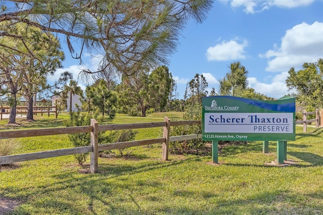 view of community with a yard and fence