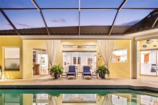 2196 Muskogee Trl, Nokomis, FL 34275 - back of house at dusk featuring a patio, an outdoor pool, and glass enclosure