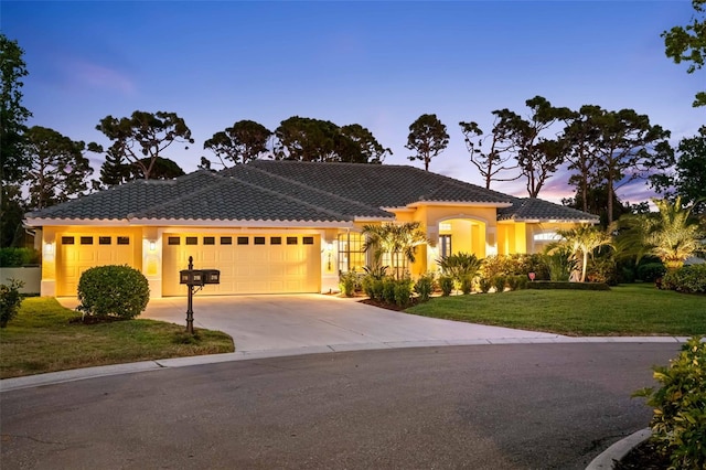 2196 Muskogee Trl, Nokomis, FL 34275 - view of front facade with a garage, a front yard, a tile roof, stucco siding, and concrete driveway