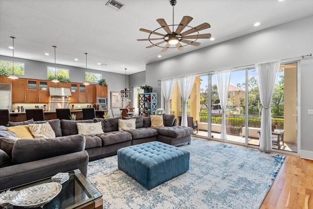 living area with visible vents, recessed lighting, and a ceiling fan