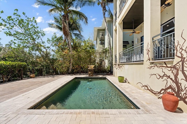 pool with a patio area and a ceiling fan