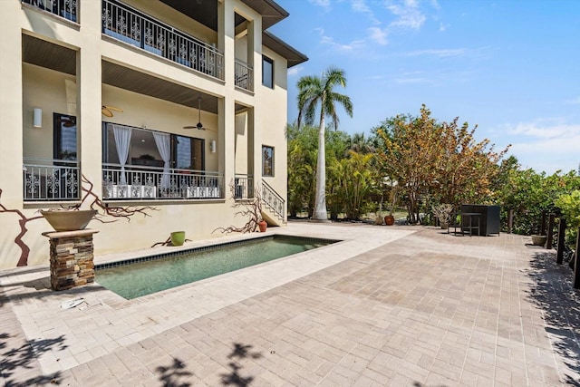 outdoor pool featuring a patio area and ceiling fan
