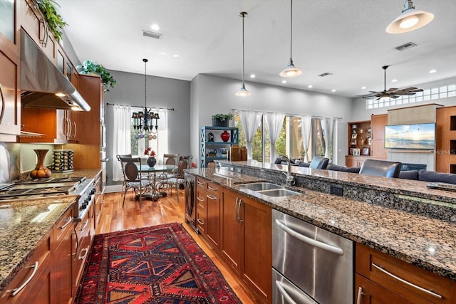 kitchen featuring a sink, visible vents, appliances with stainless steel finishes, and under cabinet range hood
