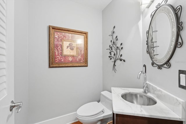 bathroom featuring toilet and vanity