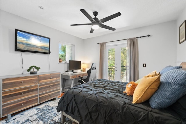 bedroom with multiple windows, access to exterior, a ceiling fan, and french doors