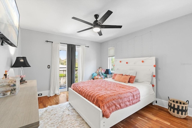 bedroom featuring access to outside, wood finished floors, baseboards, and a ceiling fan