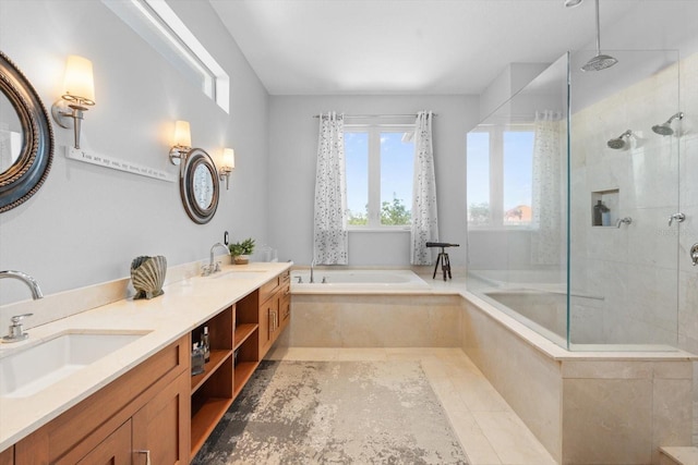 bathroom with tiled shower, a bath, and a sink