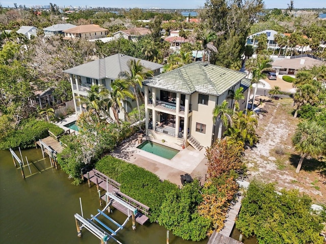 drone / aerial view with a water view and a residential view